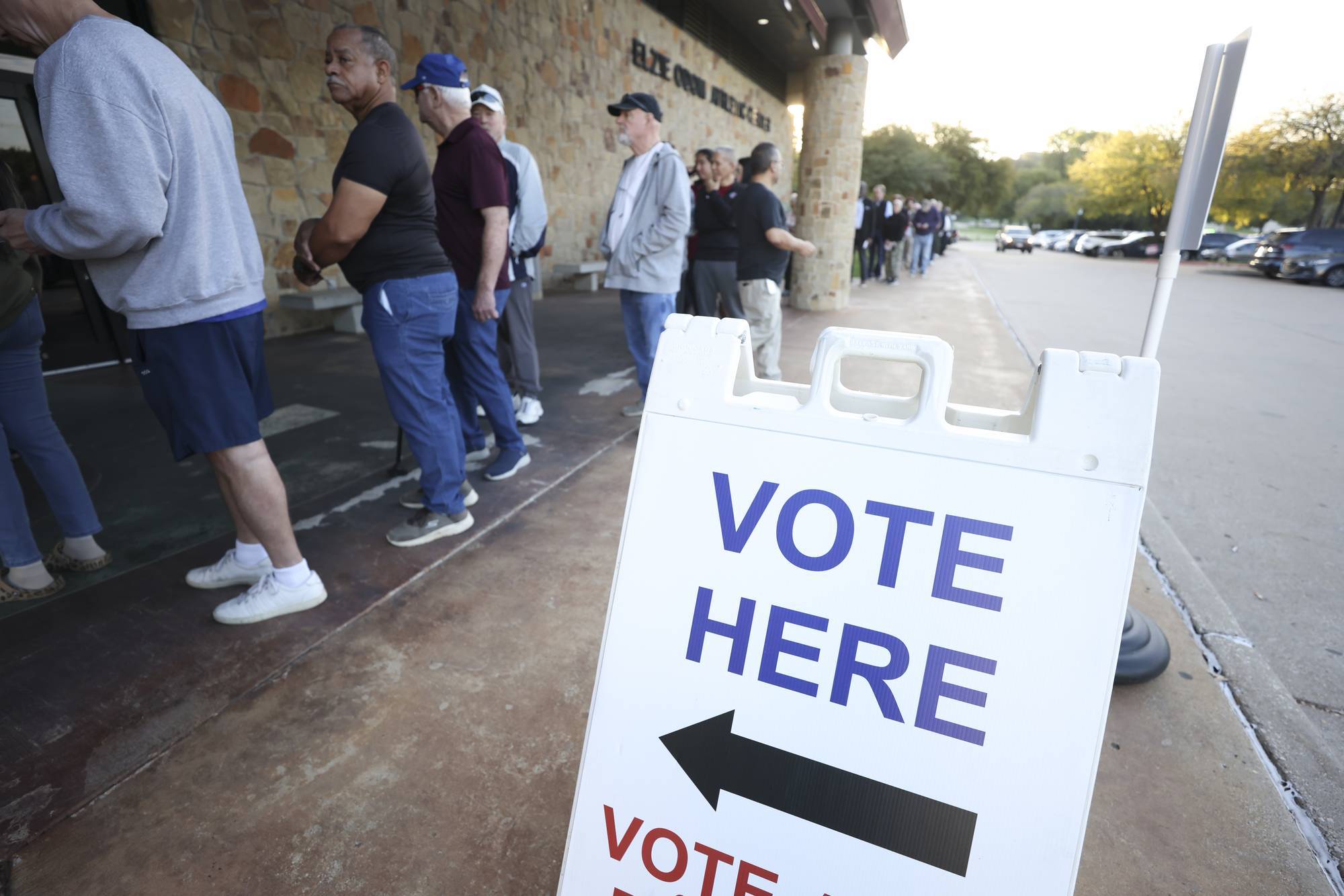 People stand in line outside Elzie Odom Athletic Center in Arlington, Texas