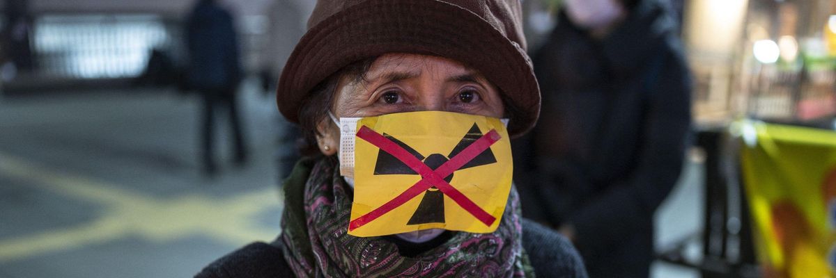 People take part in a candle vigil in memory of earthquake and tsunami victims in Mitaka, on the outskirts of Tokyo on March 11, 2022, on the 11th anniversary of the 9.0 magnitude earthquake which triggered a tsunami and nuclear disaster.