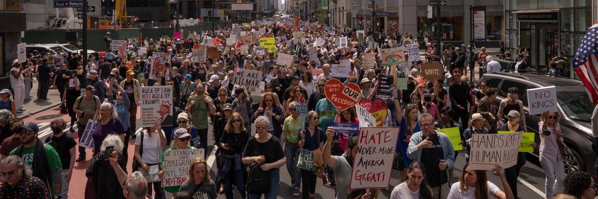 People take part in a protest against President Donald Trump's policies