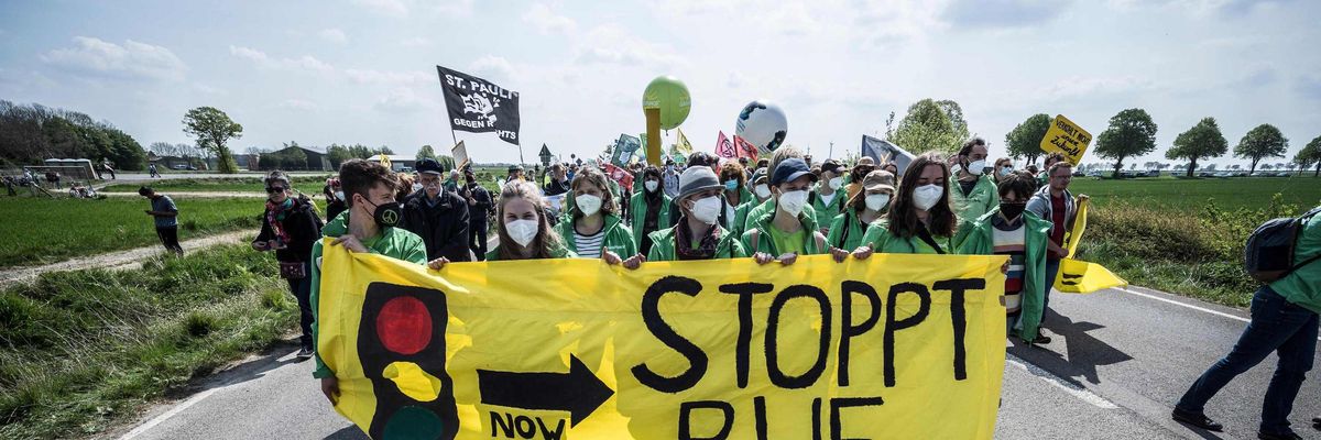 People take part in a protest against the destruction of a village for the expansion of the Garzweiler lignite open cast mine near Lützerath, western Germany, on April 23, 2022. German energy provider RWE is planning to entirely demolish houses in the village of Lützerath for coal mining. (Photo: Bernd Lauter/AFP via Getty Images)