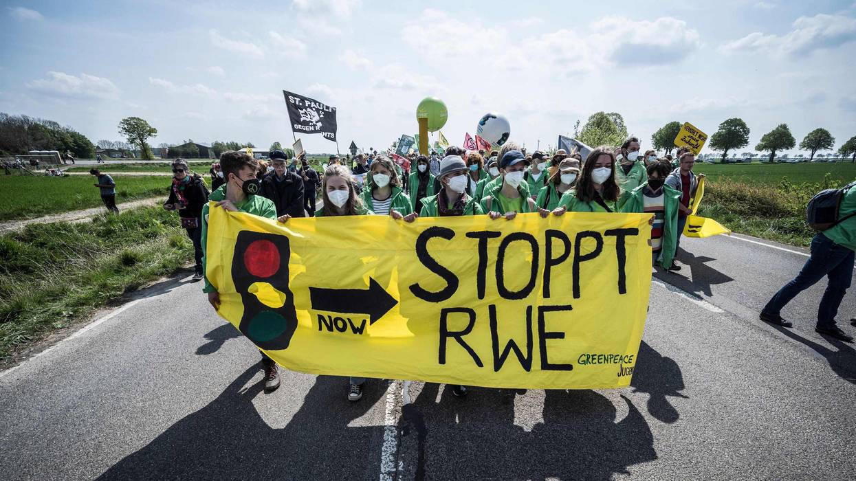 People take part in a protest against the destruction of a village for the expansion of the Garzweiler lignite open cast mine near Lützerath, western Germany, on April 23, 2022. German energy provider RWE is planning to entirely demolish houses in the village of Lützerath for coal mining. (Photo: Bernd Lauter/AFP via Getty Images)