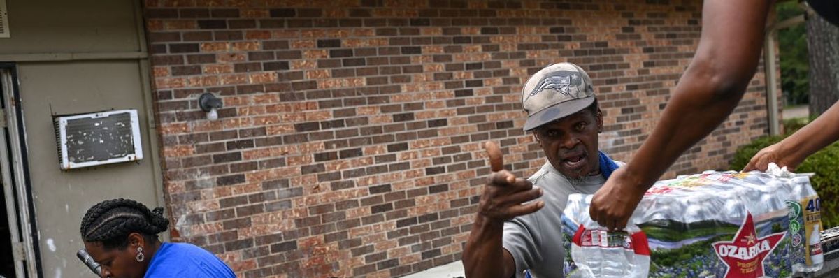 People unloading bottle water from a truck