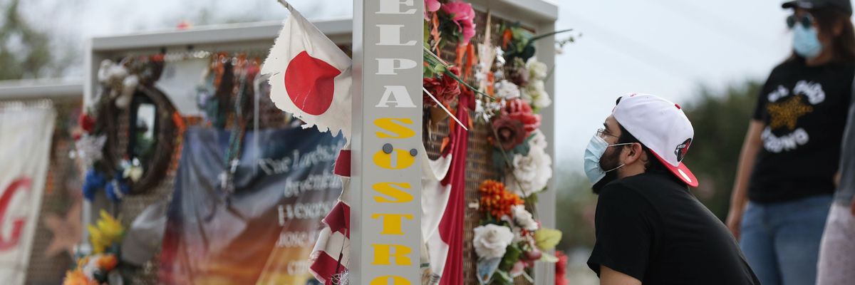  People view a temporary memorial honoring the victims of a racist shooting in El Paso