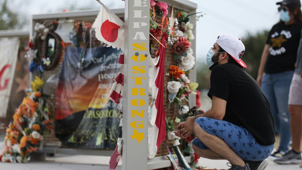 People view a temporary memorial honoring the victims of a racist shooting in El Paso