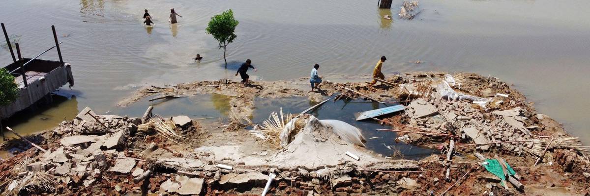 People wading through Pakistan flood waters