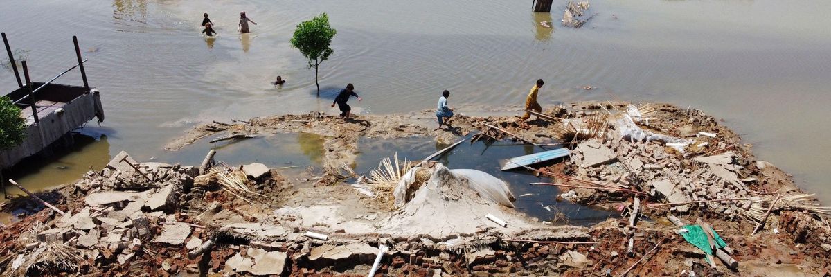 People wading through Pakistan flood waters