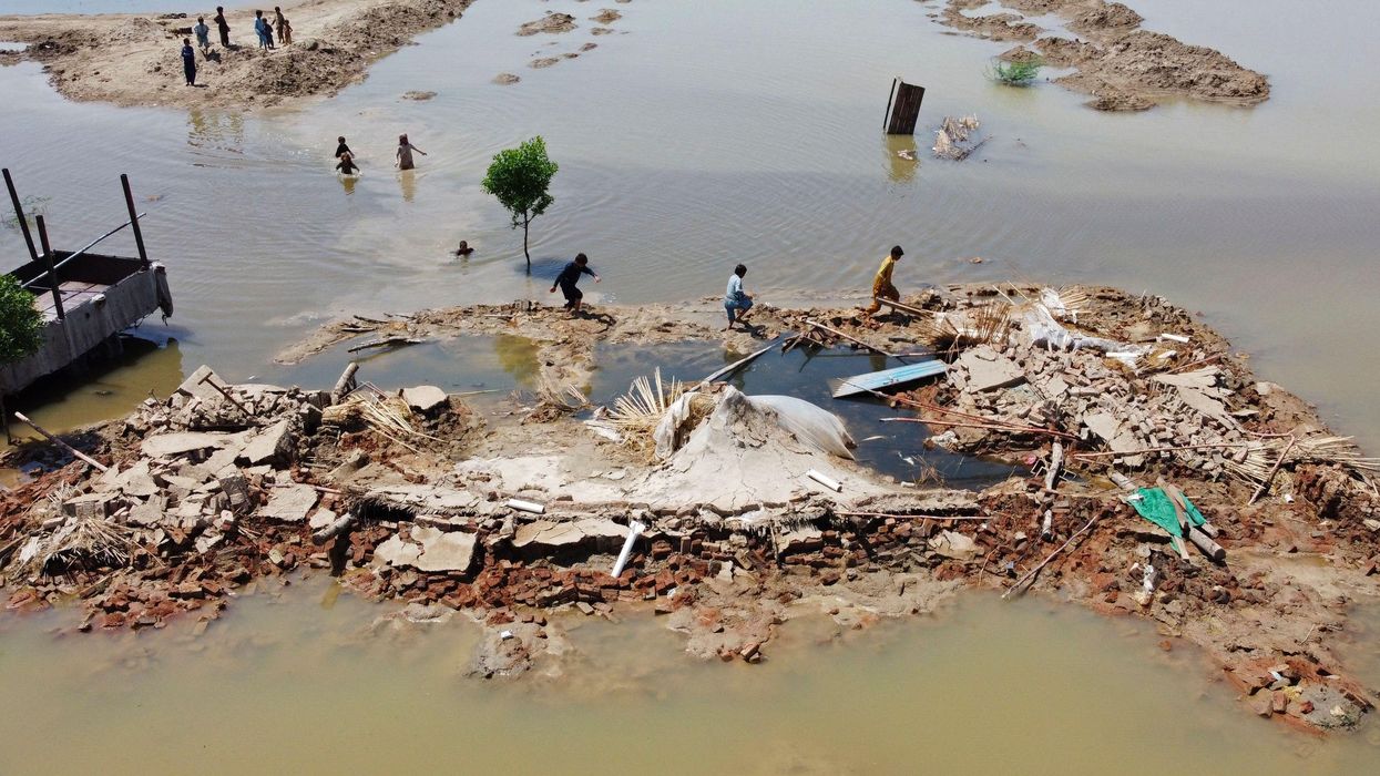 People wading through Pakistan flood waters