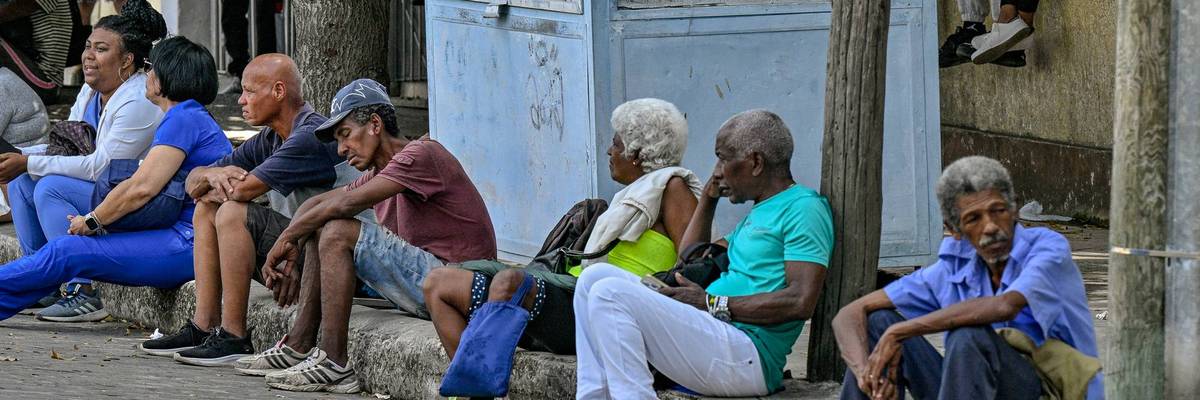 People wait at a bus stop in Havana, Cuba during a blackout on March 16, 2026.