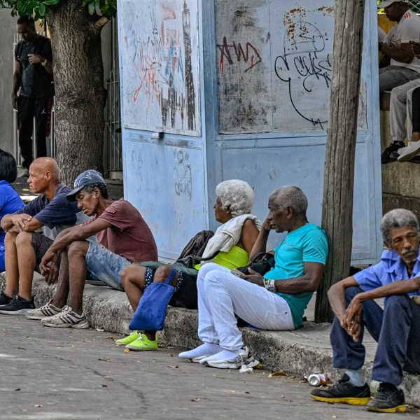 People wait at a bus stop in Havana, Cuba during a blackout on March 16, 2026.