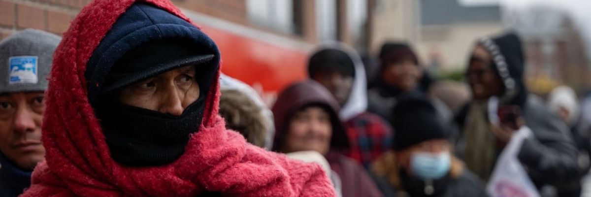 People wait for free food during Winter cold
