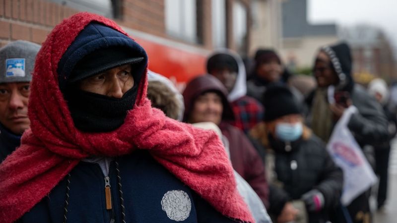 People wait for free food during Winter cold
