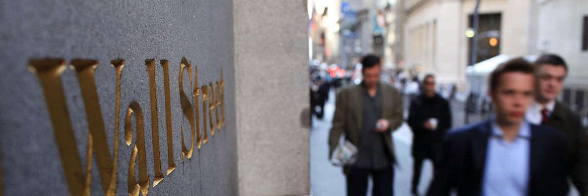 People walk along Wall Street in the financial district on April 19, 2010 in New York City.