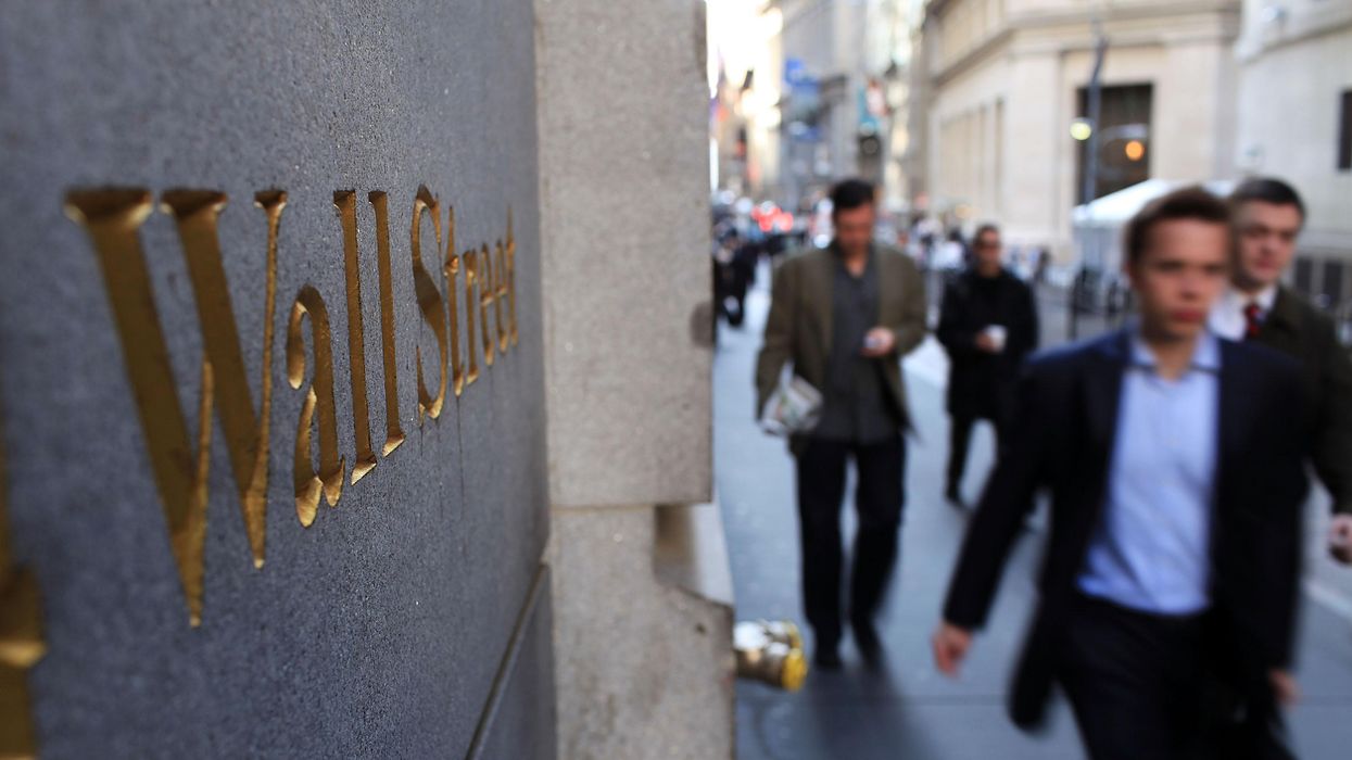 People walk along Wall Street in the financial district on April 19, 2010 in New York City.