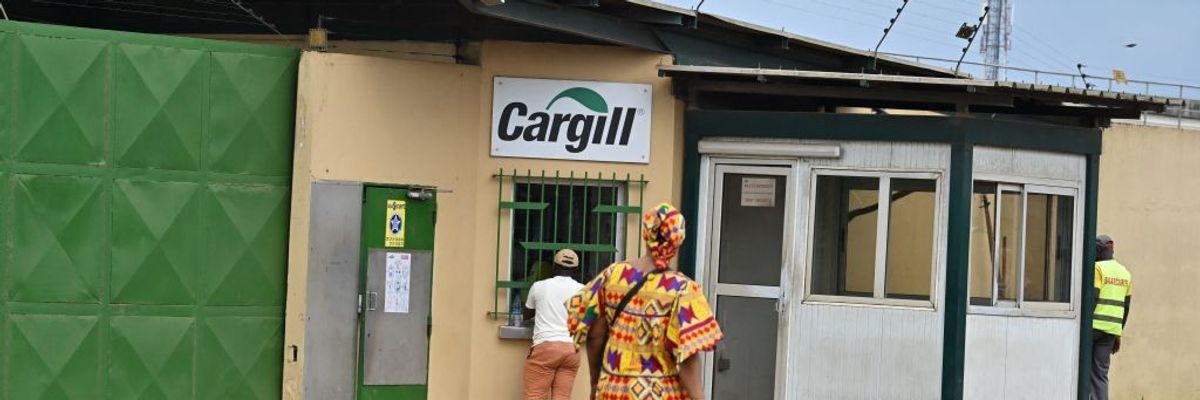 People walk past a Cargill Cocoa factory.