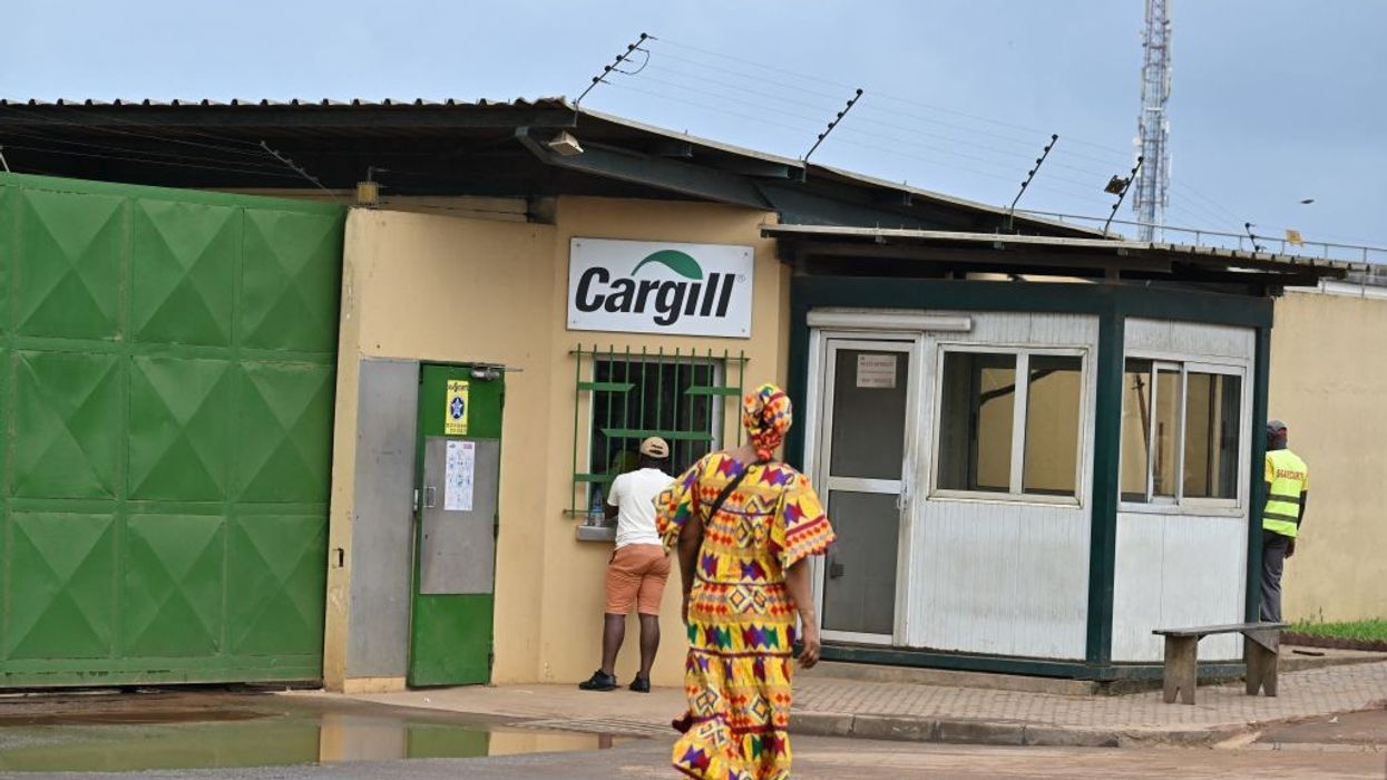 People walk past a Cargill Cocoa factory.