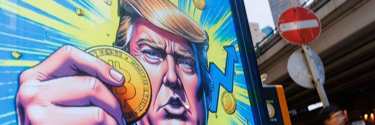 People walk past an advertisement featuring U.S. President Donald Trump with Bitcoin