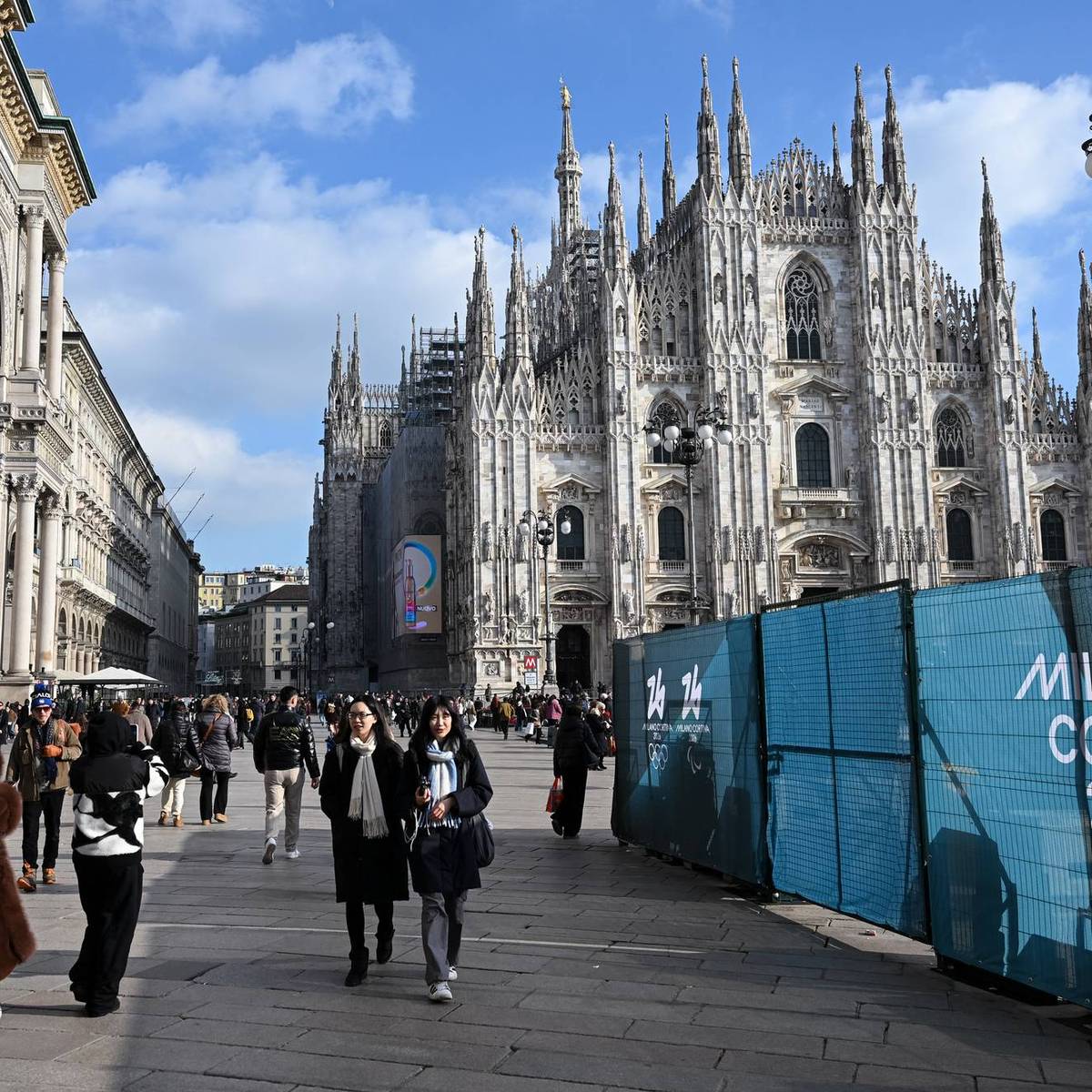 People walk past Milano Cortina 2026 Olympic Games fences