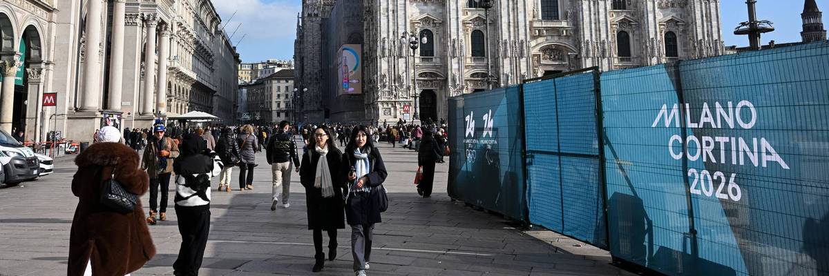 People walk past Milano Cortina 2026 Olympic Games fences