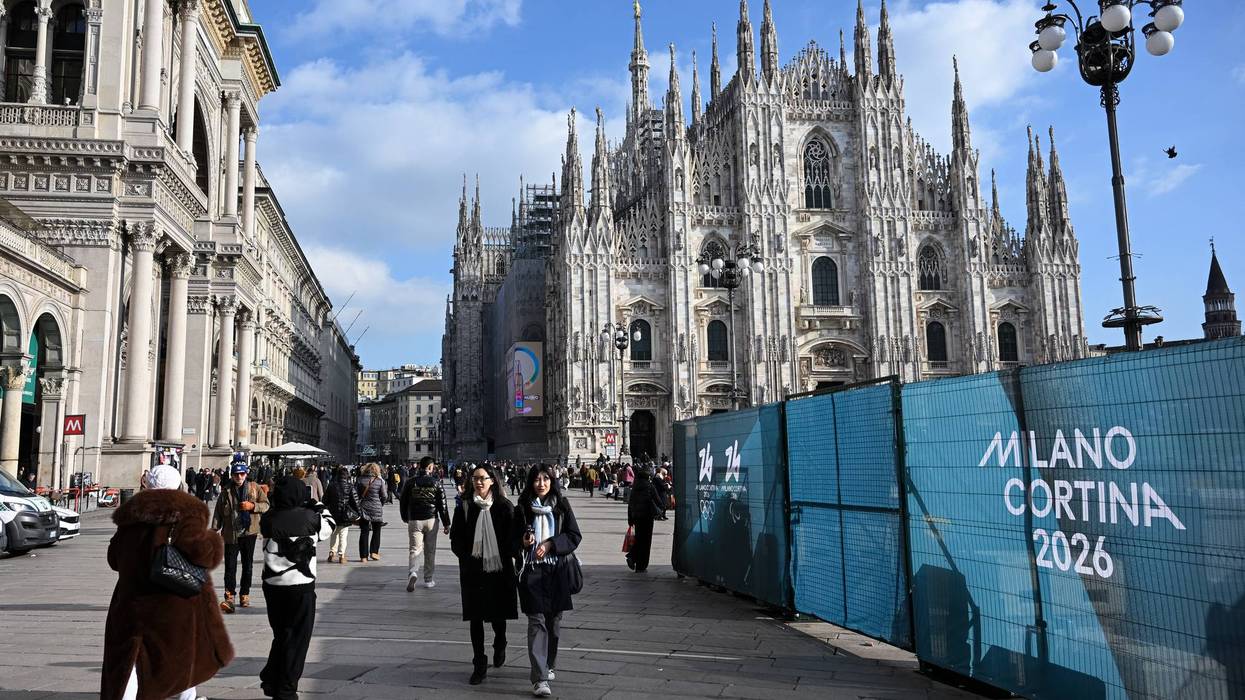 People walk past Milano Cortina 2026 Olympic Games fences
