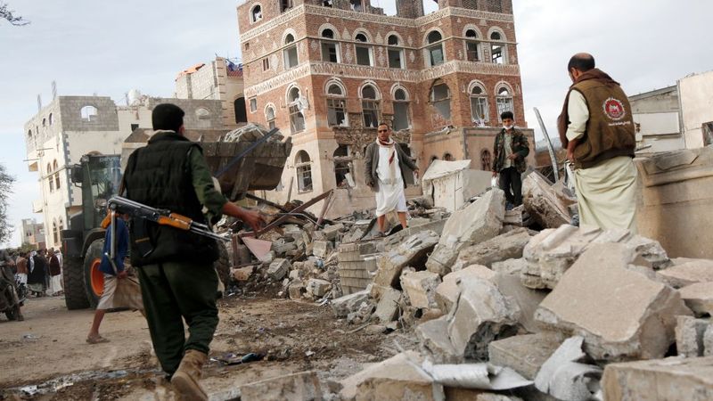 People walk through a building bombed by the U.S. in Yemen.