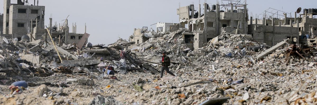People walk through ruins in Rafah.
