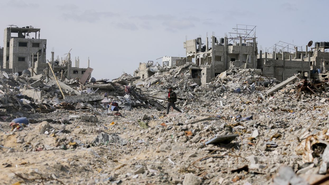 People walk through ruins in Rafah.