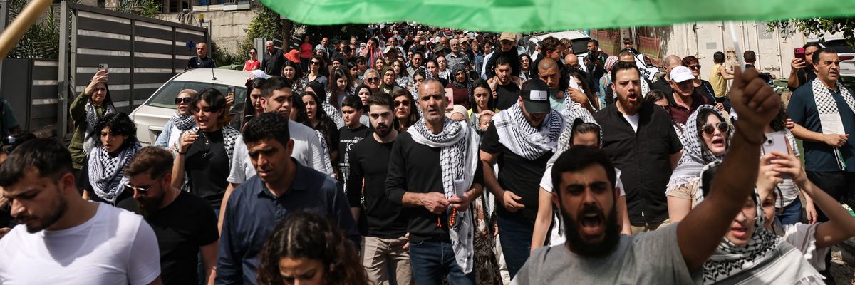 People wave Palestinian national flags