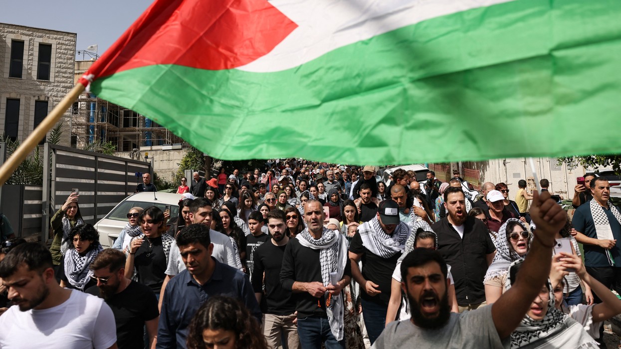 People wave Palestinian national flags