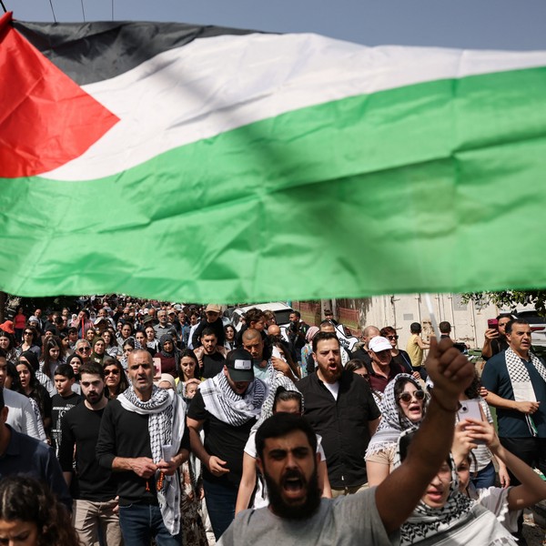 People wave Palestinian national flags