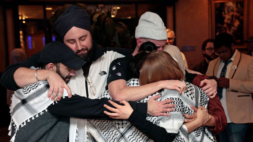 People with Listen to Michigan group hug after state's primary results came in