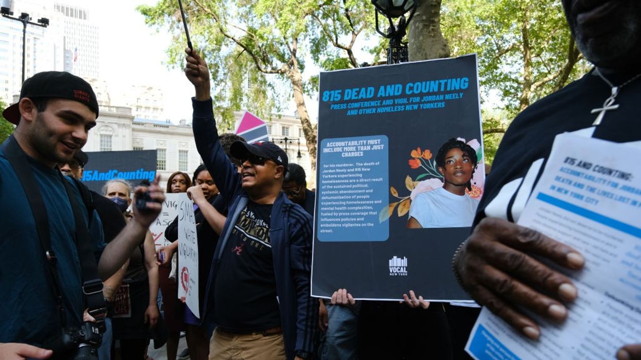 People with signs in a park.