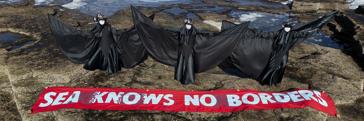 Performance artists demonstrate oil spill in Scotland.