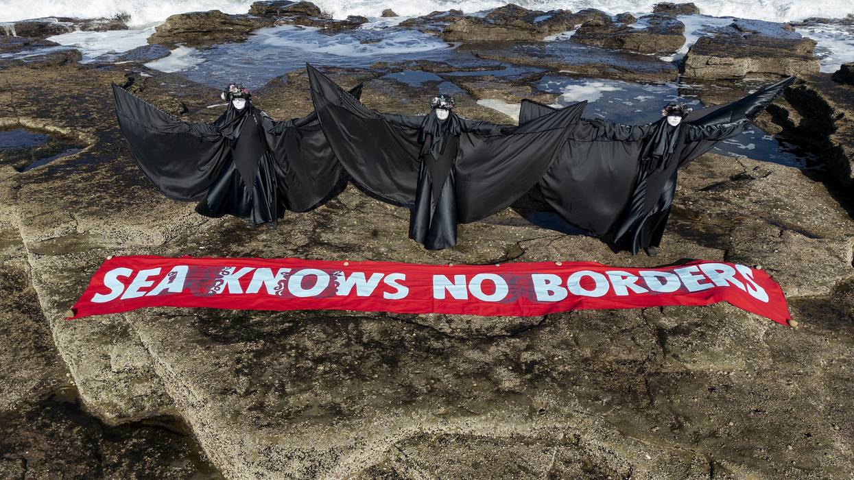 Performance artists demonstrate oil spill in Scotland.