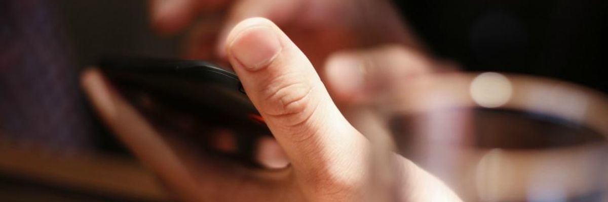 Person dialing a phone