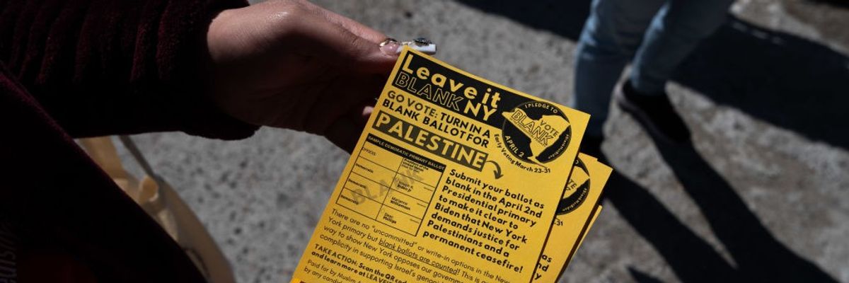 person holds a Leave It Blank flyer