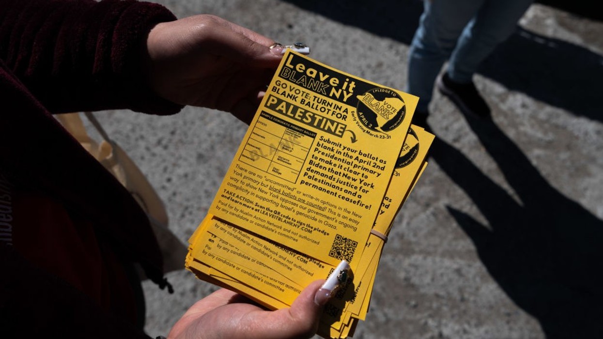 person holds a Leave It Blank flyer