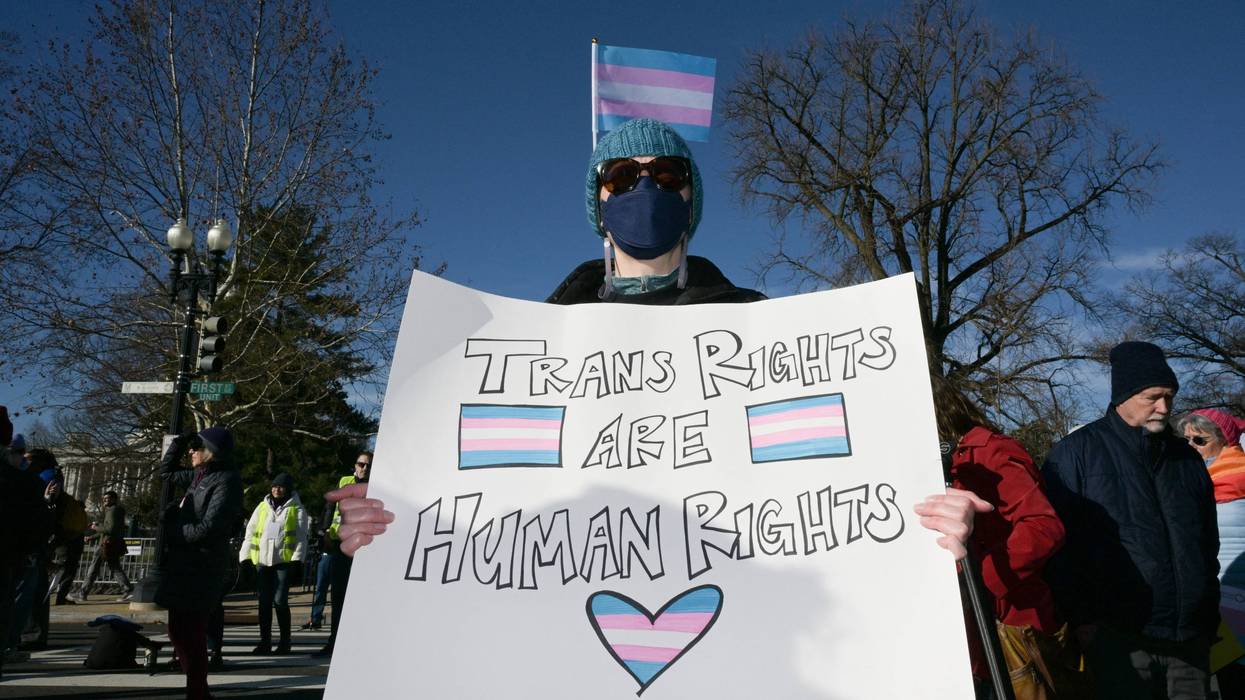 Person holds sign reading, "Trans rights are human rights."