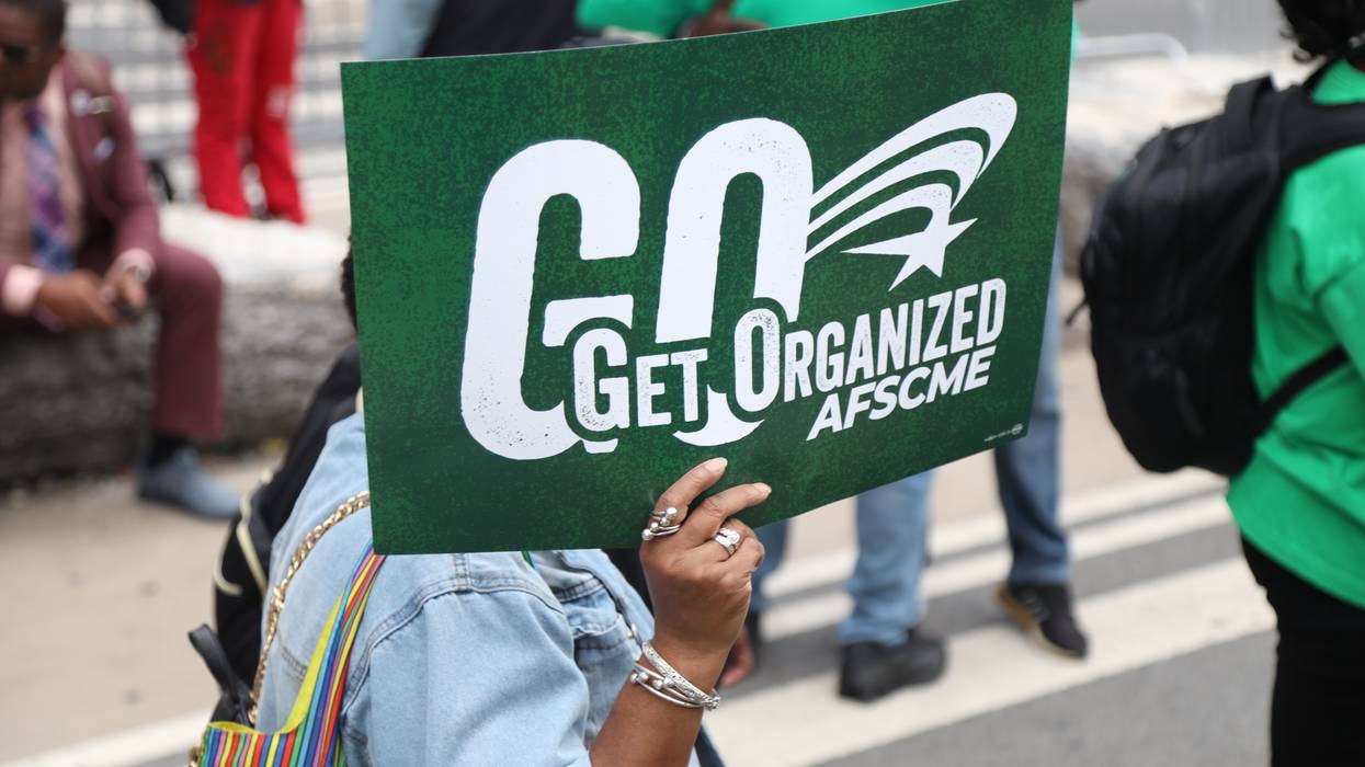 Person holds up an AFSCME sign during the 2025 National Action Network March on Wall Street.