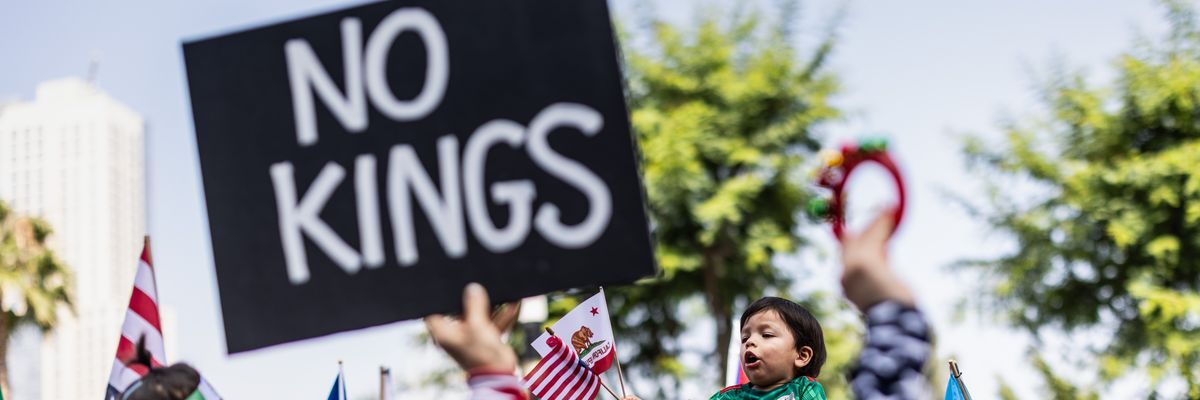 Person holds up sign reading, "No Kings."