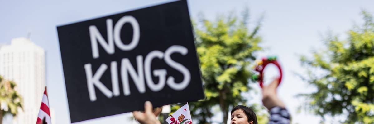 Person holds up sign reading, "No Kings."