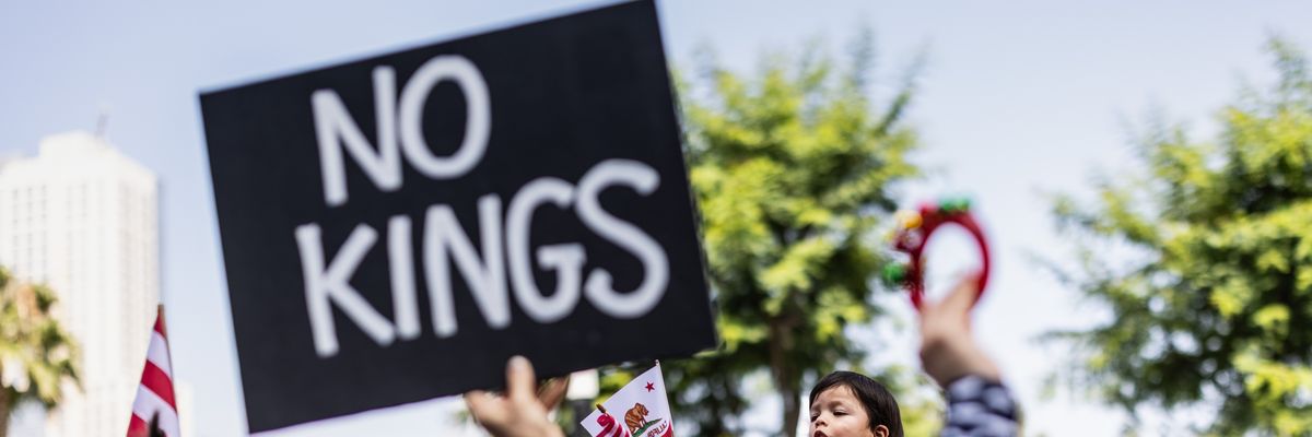 Person holds up sign reading, "No Kings."
