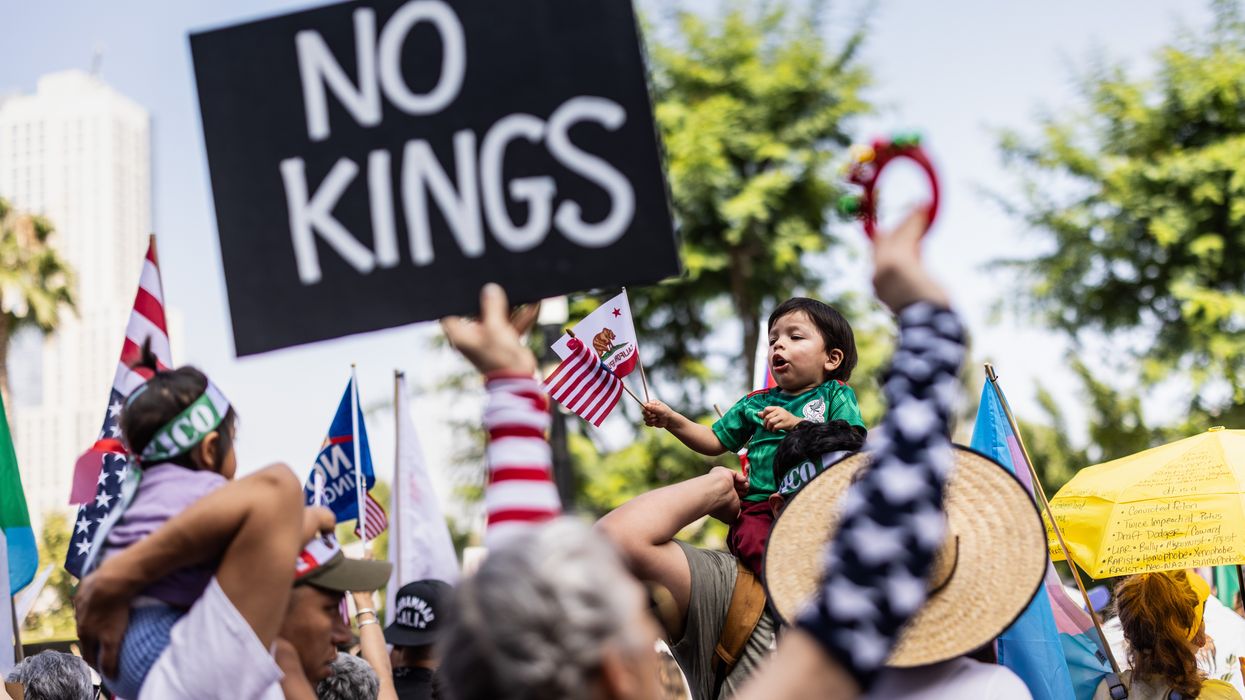 Person holds up sign reading, "No Kings."