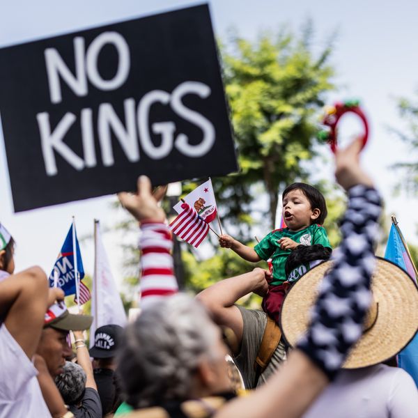 Person holds up sign reading, "No Kings."