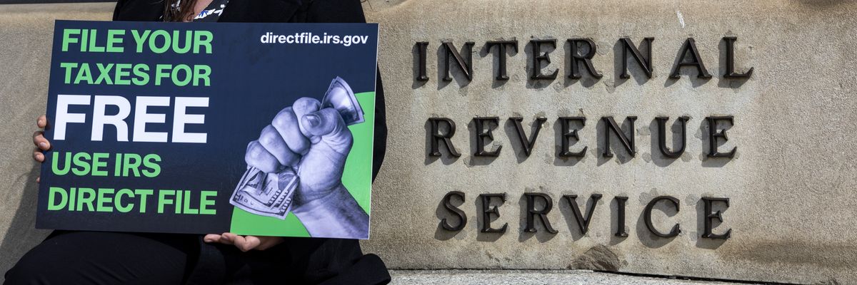 Person stands outside IRS building advocating for Direct File.