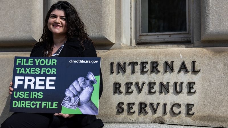 Person stands outside IRS building advocating for Direct File.