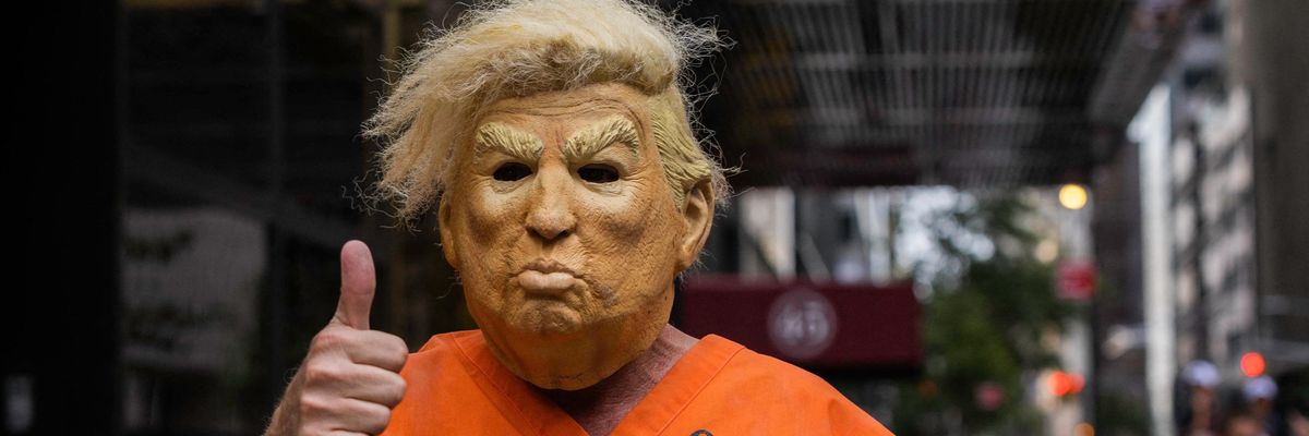 Person wearing Trump costume wearing prisoner garb