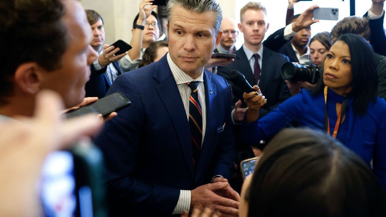 Pete Hegseth speaks to reporters.