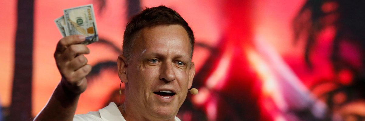 Peter Thiel holds up $100 bills.
