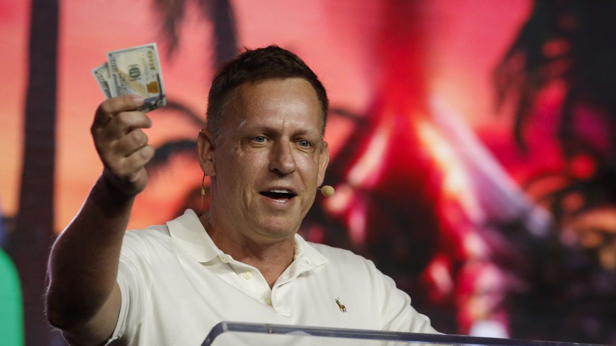 Peter Thiel holds up $100 bills.