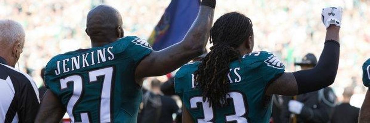 Philadelphia Eagles Malcolm Jenkins (27) and defensive back Ron Brooks (33) hold up fists during the national anthem